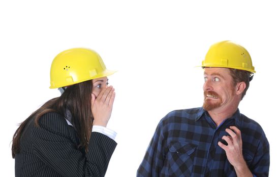 businesswoman gestures telling something to afraid construction worker on workplace