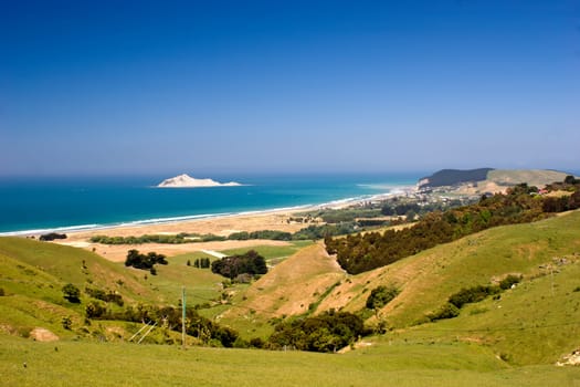 The view down to Bare Island and the coastal settlement of Waimarama in Hawke's Bay, East Coast of the North Island, New Zealand.