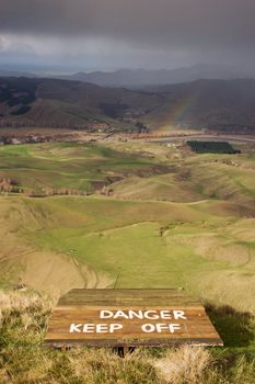 A warning painted onto a launching ramp for hang gliders and para gliders on Te Mata Peak, Havelock North, Hawke's Bay, New Zealand. View is of Tukituki valley towards the east coast.