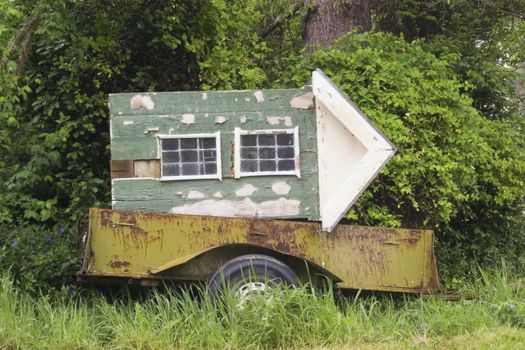 A playhouse sits on an old rusty trailer waiting for a new lease of energy and life