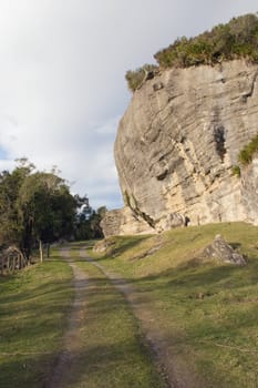 A country road winds around wind eroded limestone cliffs