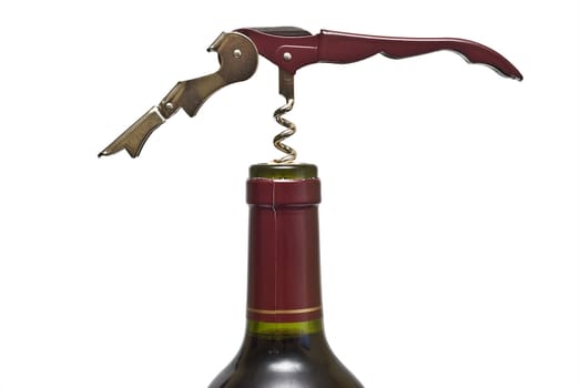 Corkscrew opening a red wine bollte over a white background.