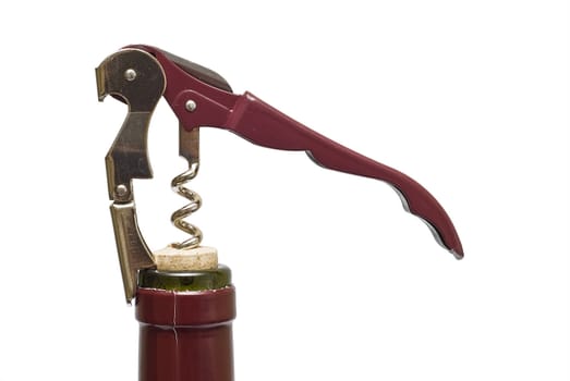 Corkscrew opening a red wine bollte over a white background.