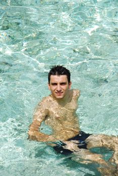 young adult smiling on translucid water in a Maldivian Island