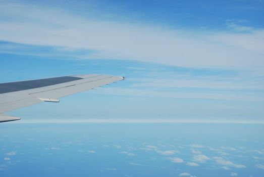 photo of a airplane wing and clouscape scene