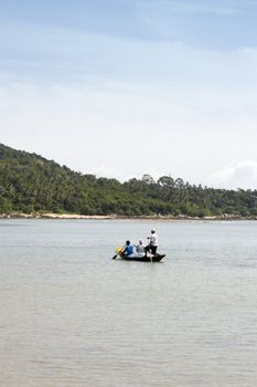 Fishermen on a longtail boat on the coast of Koh Samui, Thailand