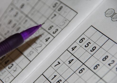 photo of a pencil on a famaous sudoku grid (shallow depth of field)