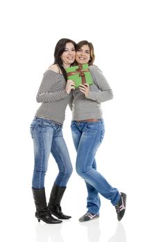 Two beautiful young women�s holding a present
