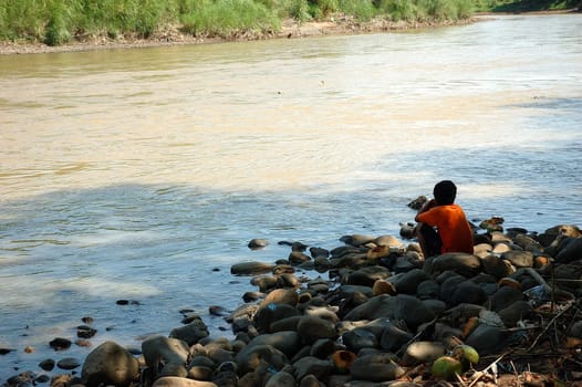 man doing for fishing beside the river