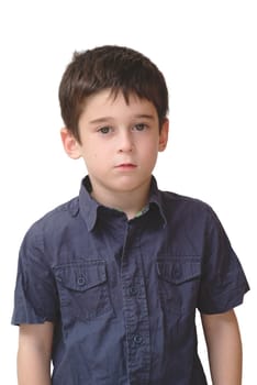 Serious cute little old boy stands isolated on white background