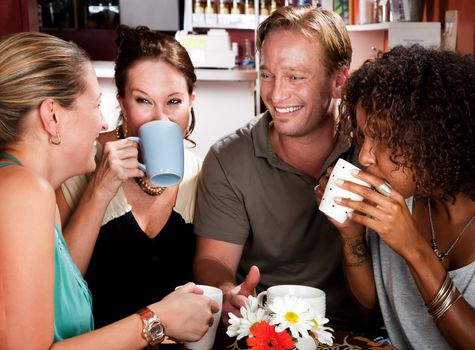 Diverse group of four friends in a coffee house