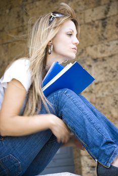 beautiful young woman reading book outdoor