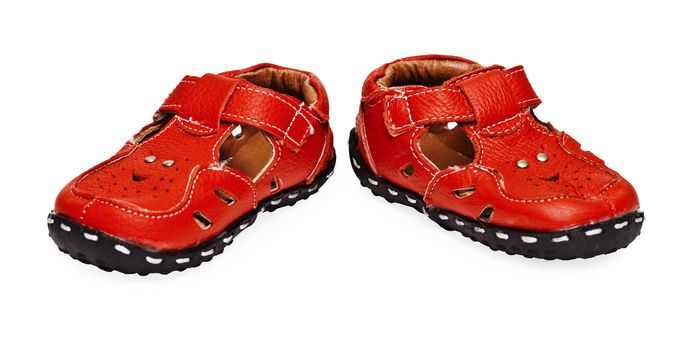 A pair of red children's leather shoes on a white background