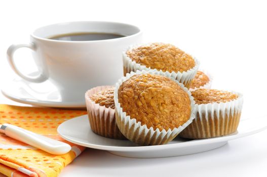 Plate of homemade oatmeal muffins served with coffee.