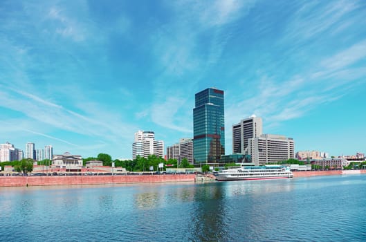 High-rise building on the riverbank. Urban landscape of Moscow.