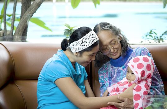 photo of 3 generation woman: a baby, mom and grandma having a good time together