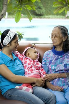 photo of 3 generation woman: a baby, mom and grandma having a good time together