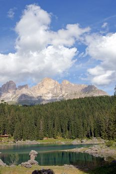 Scenic view of Carezza lake in the italian region of Trentino-Alto Adige (South Tyrol) and the Dolomites chain of the Latemar