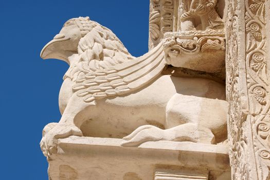 Detail of Ruvo di Puglia Cathedral in the southeast italian region of Apulia in Italy. The simple but elegant facade shows a lot of statues with vegetal, animal and human details. The Cathedral was dedicated to Santa Maria Assunta and was built between 12th and 13th century.