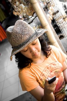 photo of asian female teens enjoy texting while shopping on a local market