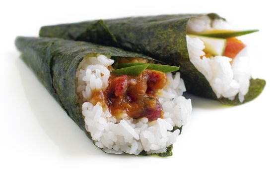 Hand rolled temaki sushi traditional japanese cuisine isolated on white.