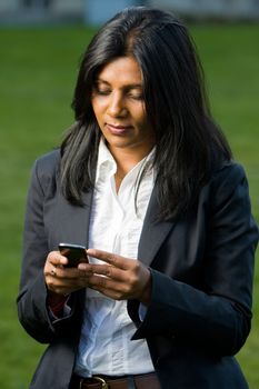 Pretty indian girl using mobile or handphone for communication