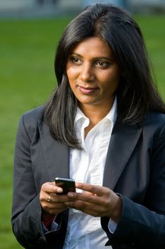 Pretty indian girl using mobile or handphone for communication