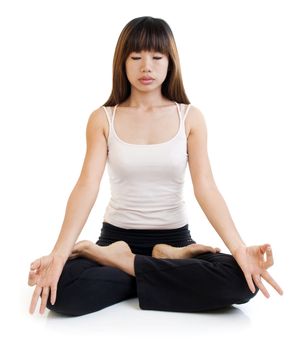 Young Asian woman having meditation with lotus position on white background.