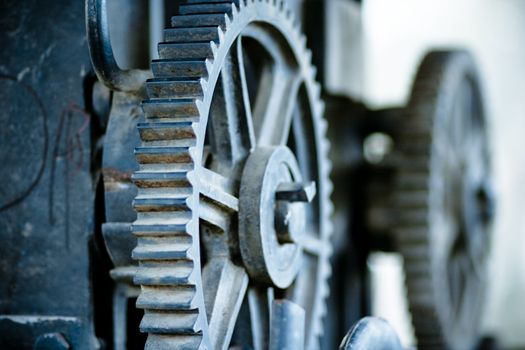 large old industrial gears set in blue metallic toning