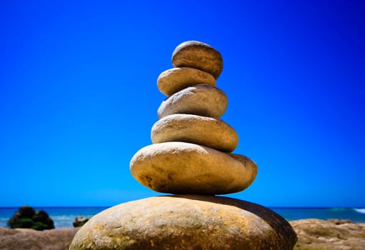 Abstract triumphal arch from a natural stones on a background of the sea
