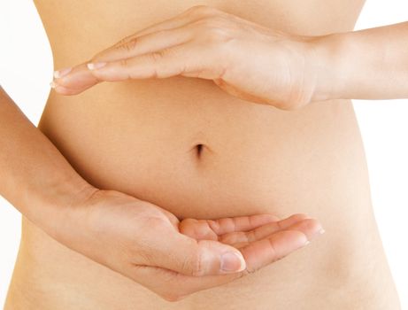 Women holding her hands in circle shape in front of her stomach.