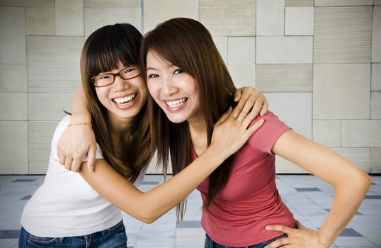 Two young Asian university students in campus.