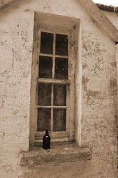 an old decaying window and bottle in ireland