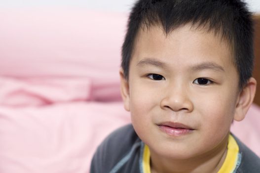 Photo of Asian young boy looking at camera.