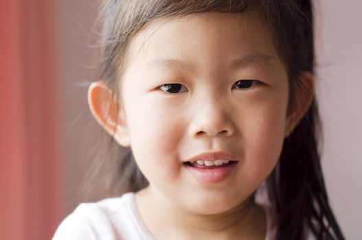 Portrait of a little Asian girl with smiling face.