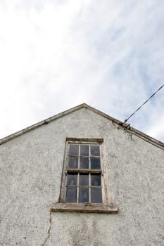 an old decaying window and sky in ireland