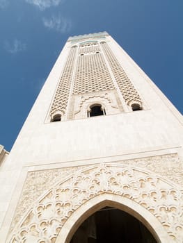 Tower of mosque in Casablanca. Blue sky summer day.