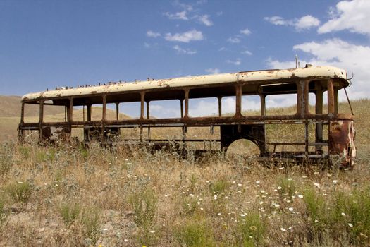 Old broken bus on the meadow in Armenia.