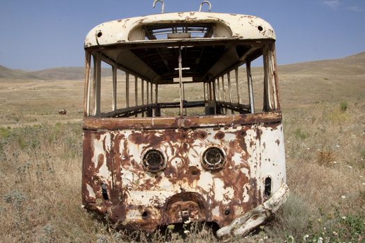 Broken bus on the meadow - Armenia. Summer day.