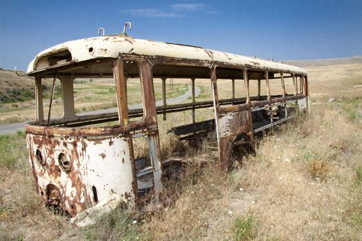 Old bus on the meadow in background small route. Armenia