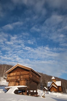 storehouse with stave church in background