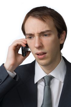 Young professional cringes on the phone, isolated over white