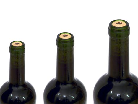 Necks of three bottles of wine on white background