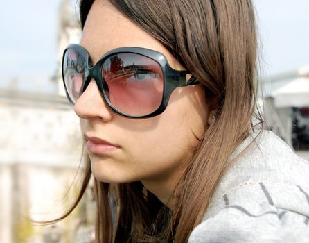 portrait of teenage girl tourist in sunglasses with mirrored Padua, Prato della Valle, Italy