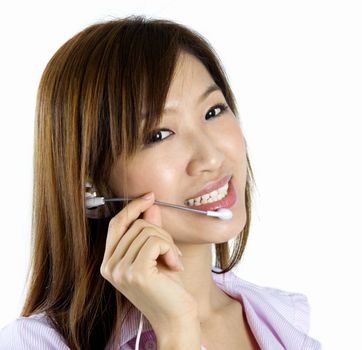 Friendly Customer Representative with headset smiling during a telephone conversation.