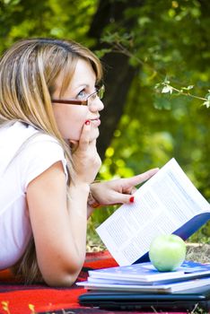 beautiful young woman working out with laptop and reading books