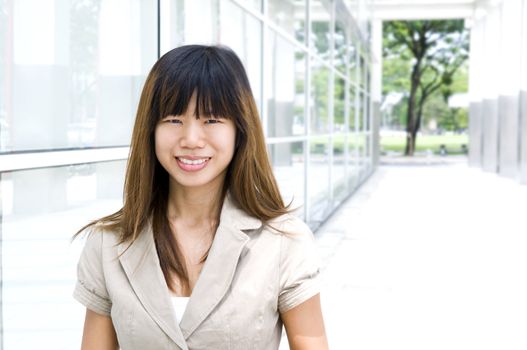 Businesswoman walking by an office building.