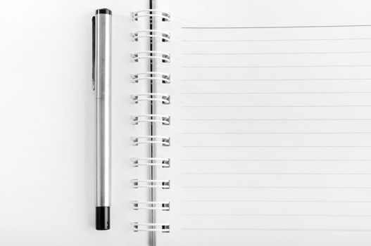 Blank notepad with a pen 