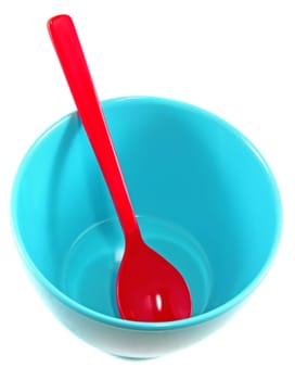 Red spoon in blue bowl isolated on white