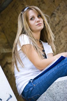 beautiful young woman reading book outdoor